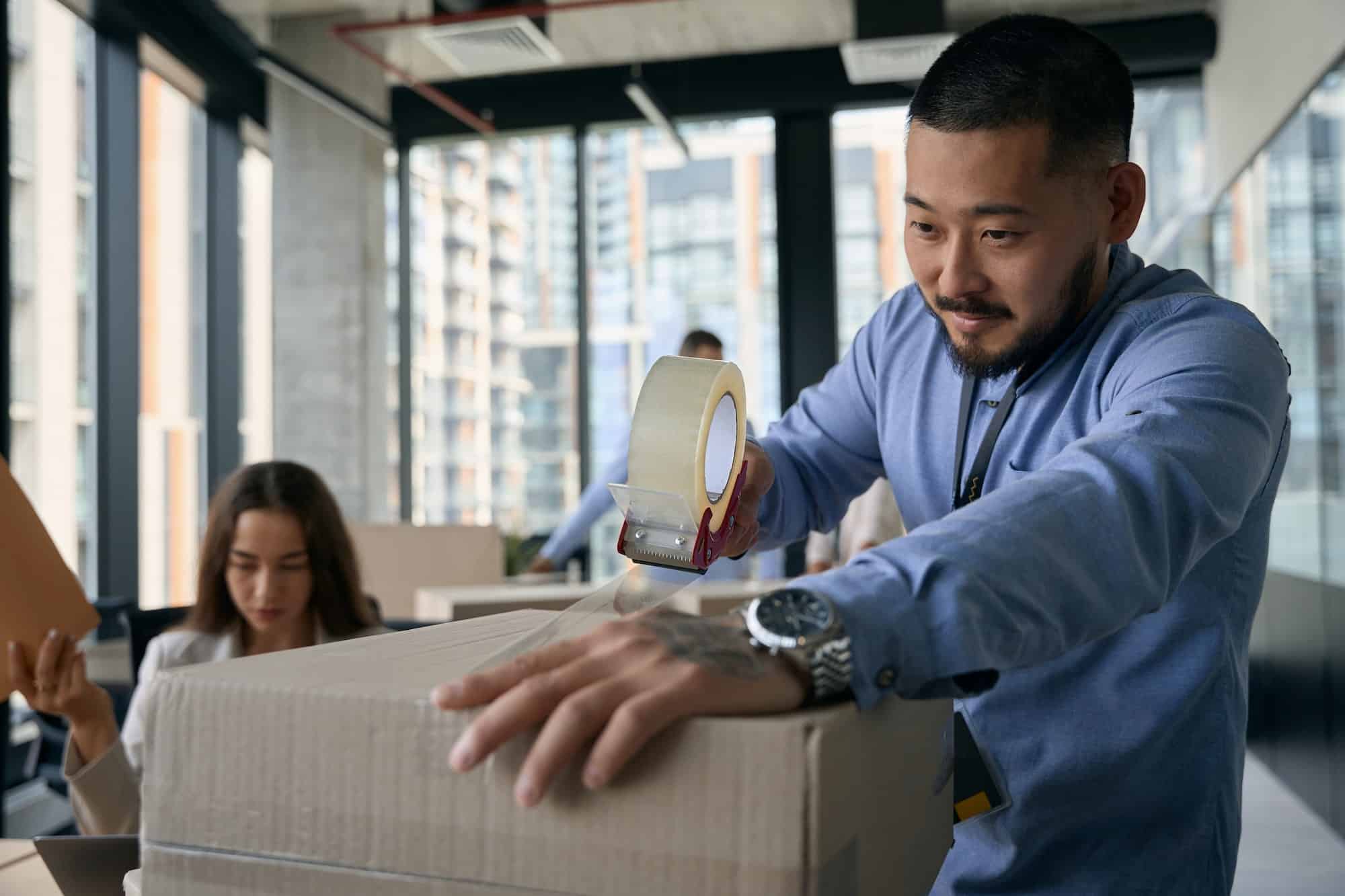 Corporate employee and his colleague preparing for office move