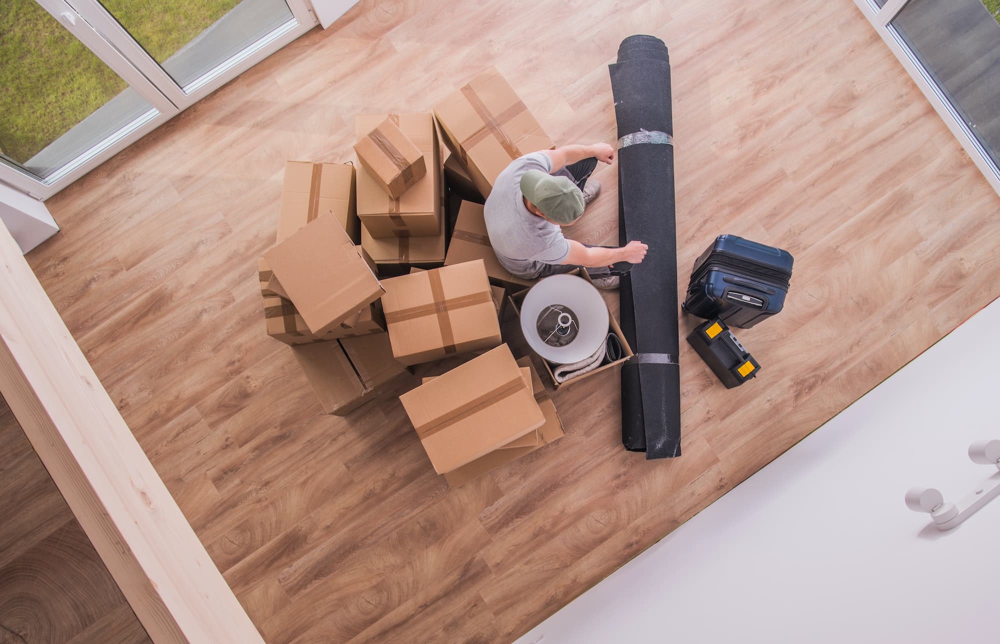 Male Proferssional Mover With Boxes And Random Hopusehold Pieces.
