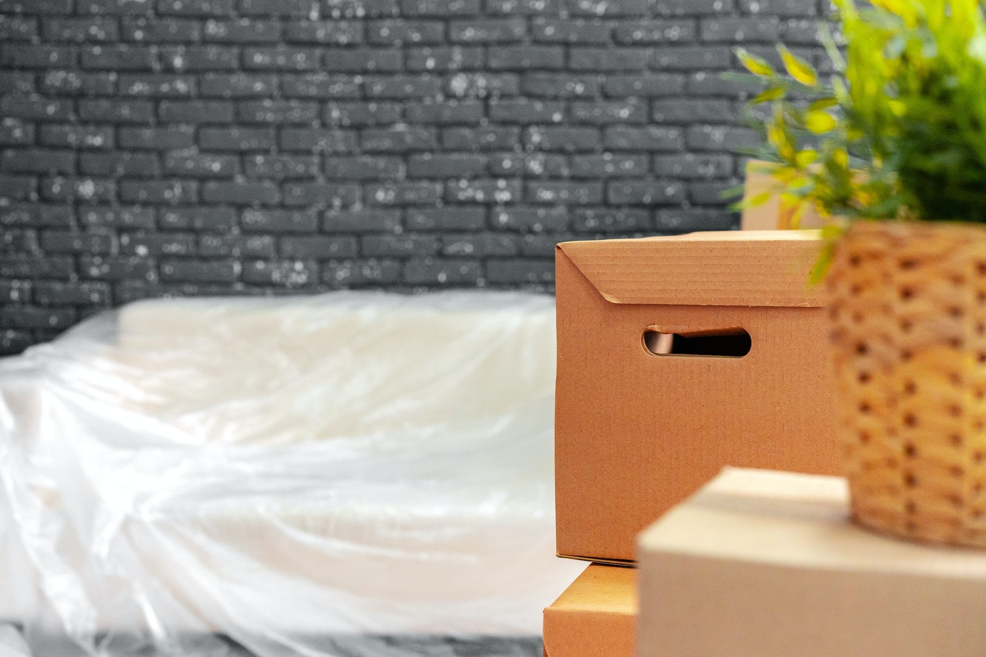 Moving in or moving out concept. Stack of boxes and packed furniture