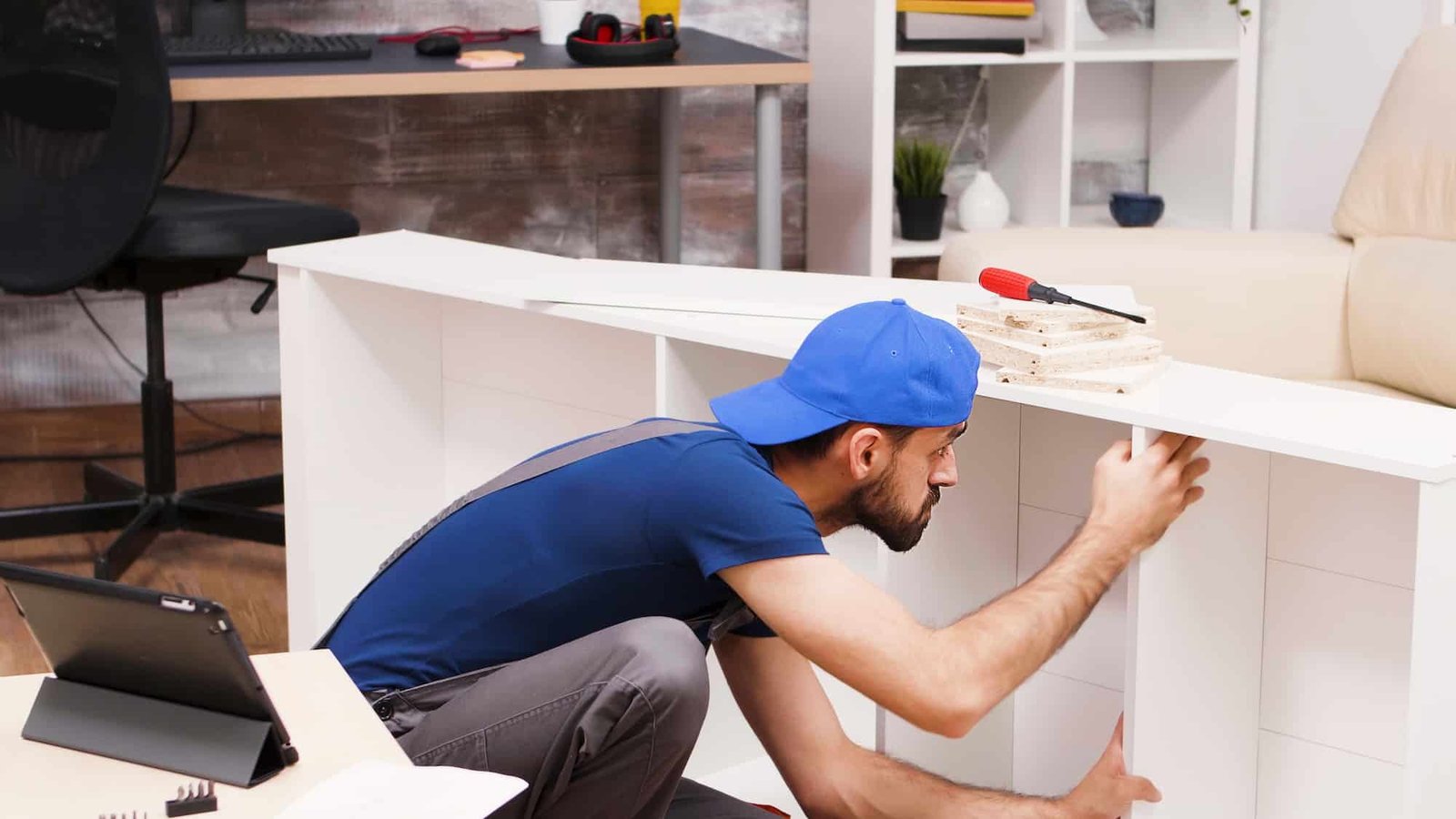 Attractive handyman assembles new furniture